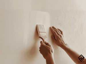 A painter applying primer to a wall before painting.